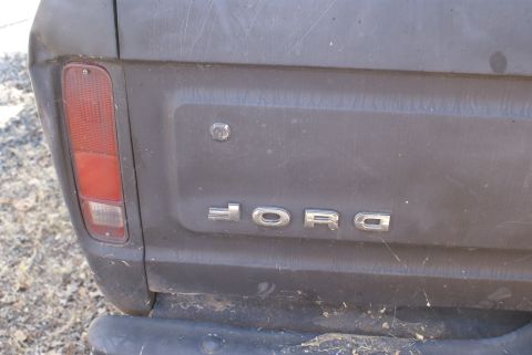 1978 Ford Bronco - Close-up of the rear of a 1978 Ford Bronco, highlighting the 'FORD' emblem and taillight assembly.