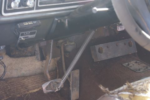 1978 Ford Bronco - The interior of a 1978 Ford Bronco, with a focus on the driver's side footwell and dashboard details.