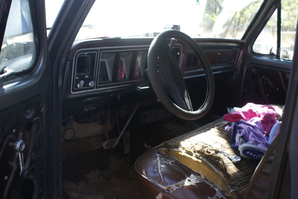 1978 Ford Bronco interior with worn seats and dashboard