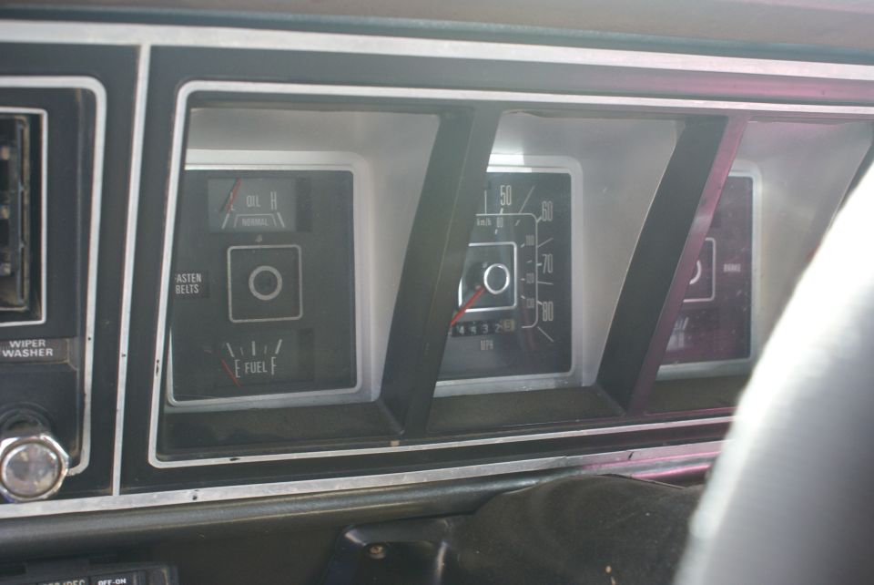 Dashboard gauges of a 1978 Ford Bronco, showing oil pressure, fuel level, and speedometer