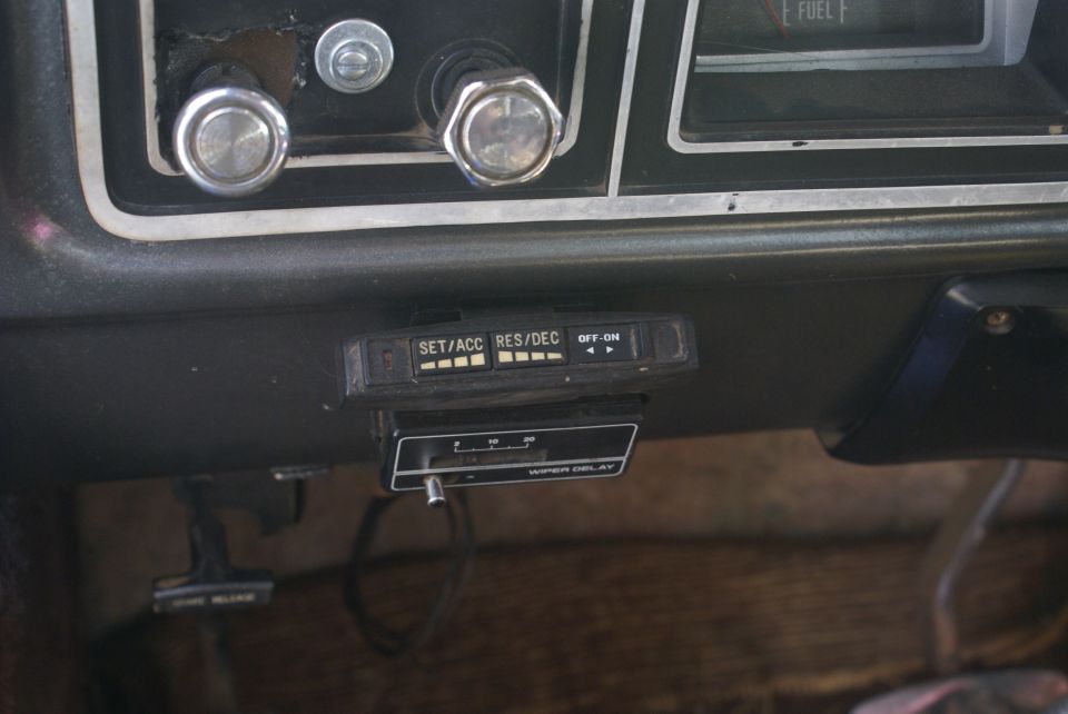 Interior dashboard of a 1978 Ford Bronco showing cruise control and wiper delay switches