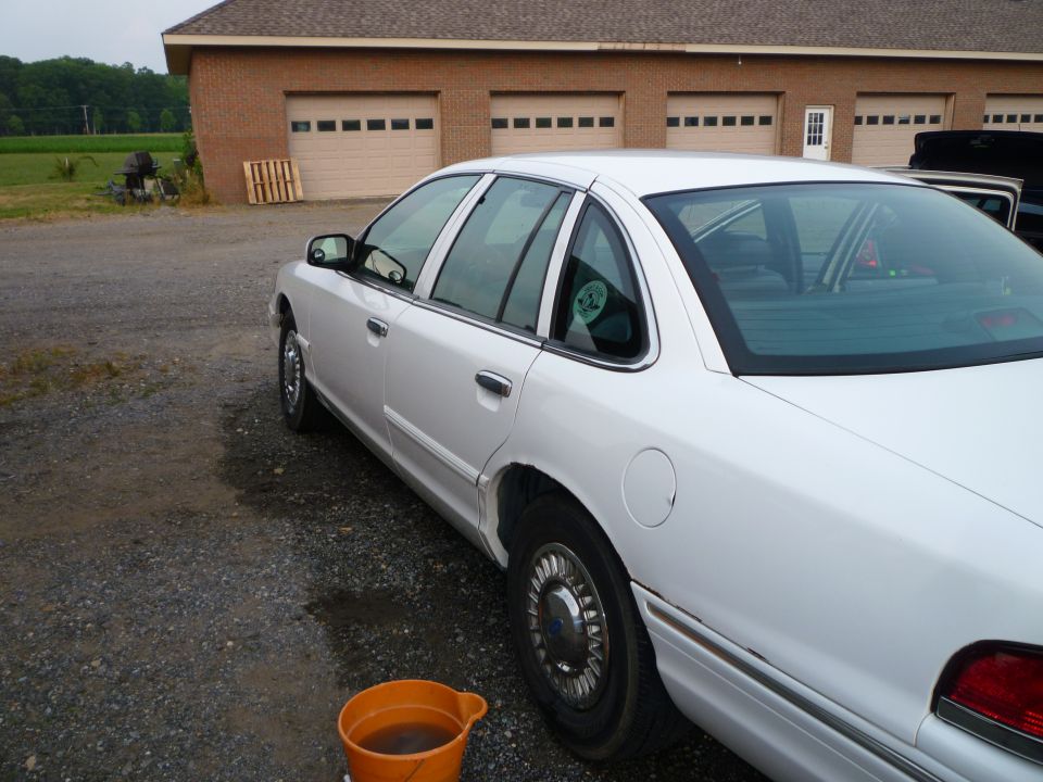 1997 Ford Crown Victoria parked on gravel lot, side view