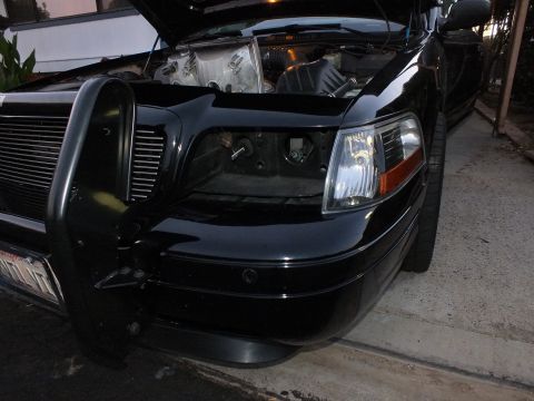 2003 Ford Crown Victoria - Dusk shot of the Crown Victoria with one headlight removed, push bar and billet grille on the left