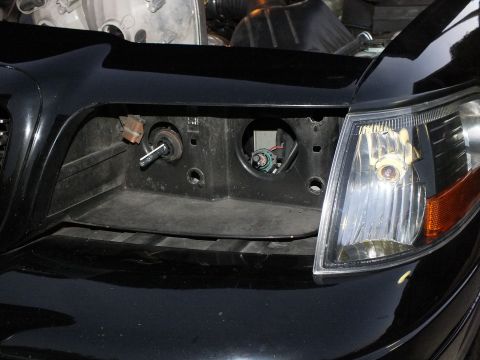 2003 Ford Crown Victoria - Close view of the vacant headlight pocket with bulb sockets and amber side marker on the Crown Victoria