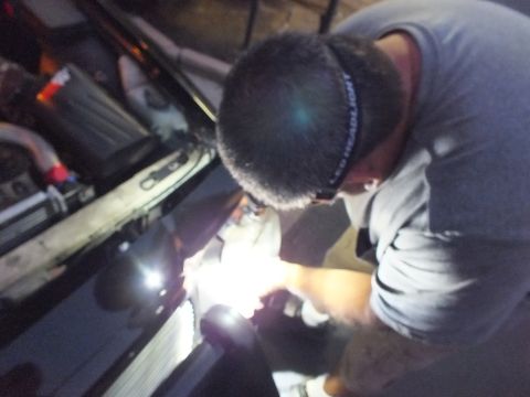2003 Ford Crown Victoria - Close night shot of a man in an LED headlamp focused on the Crown Victoria headlight install
