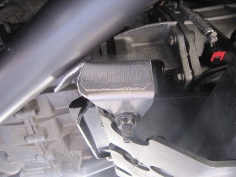 2008 Jeep Wrangler - Close-up view of vehicle undercarriage components, including a skid plate and exhaust system.