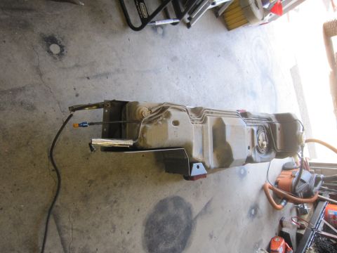 2008 Jeep Wrangler - A detached fuel tank assembly is shown on a concrete surface, disconnected from any vehicle.