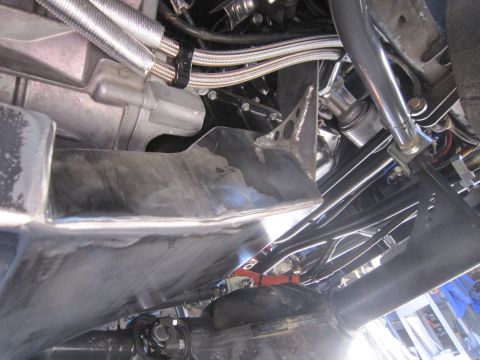 2008 Jeep Wrangler - The underside of a vehicle is shown, revealing a skid plate and various mechanical parts.