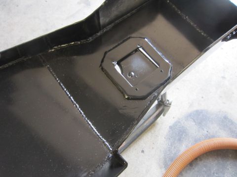 2008 Jeep Wrangler - A close-up view of a black metal skid plate, showing its construction and mounting points.
