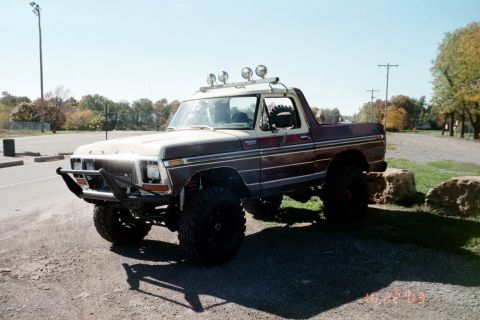 1979 Ford Bronco - This modified Ford Bronco sits parked outdoors on a sunny day.