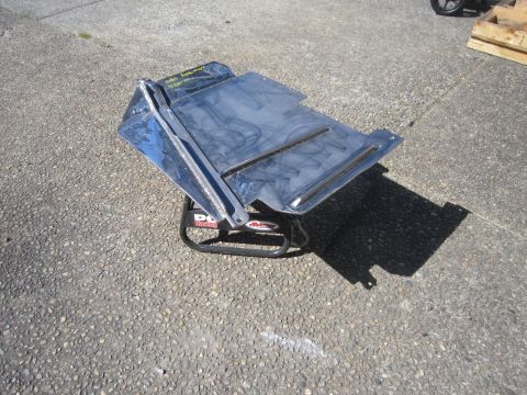 2008 Jeep Wrangler - A shiny chrome skid plate is displayed on a black stand outdoors.