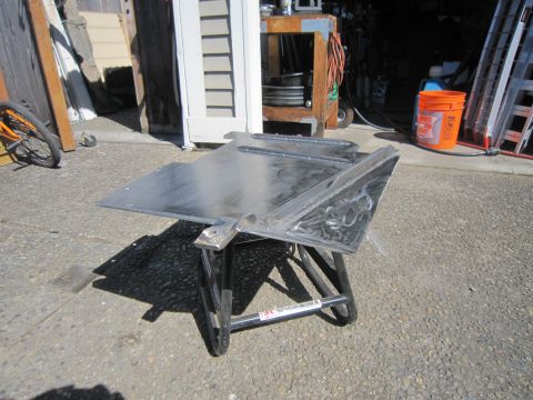 2008 Jeep Wrangler - Custom metal skid plate on a stand, likely for off-road vehicle protection.