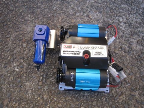 2008 Jeep Wrangler - An ARB dual air compressor with a blue filter is shown mounted on a metal plate.