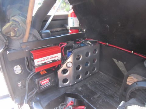 2008 Jeep Wrangler - The interior of a vehicle's cargo area is equipped with a power inverter and a winch for off-road use.