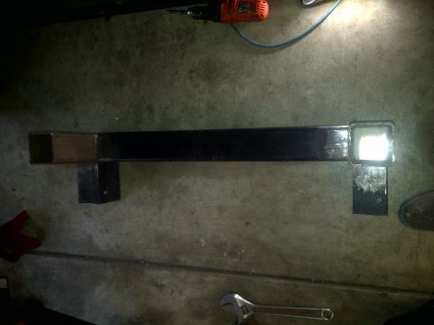 1995 Ford Bronco - Custom metal fabrication part shown on concrete floor with tools nearby.