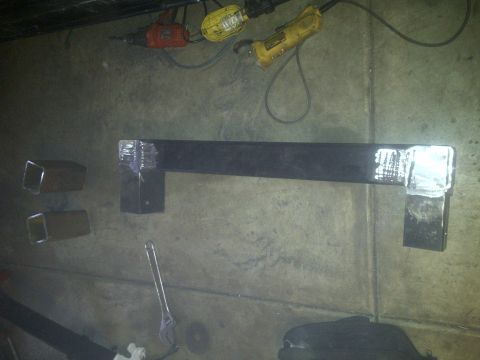 1995 Ford Bronco - Metal fabrication parts and tools are laid out on a concrete floor.