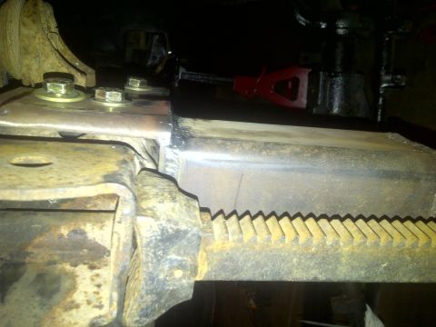 1995 Ford Bronco - This image shows a close-up view of a vehicle's steering linkage, focusing on the mechanical components.