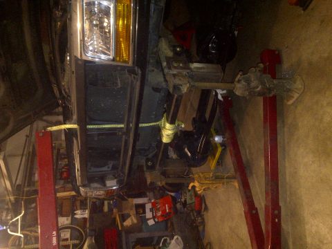 1995 Ford Bronco - Front view of a 1995 Ford Bronco being worked on, lifted for maintenance.