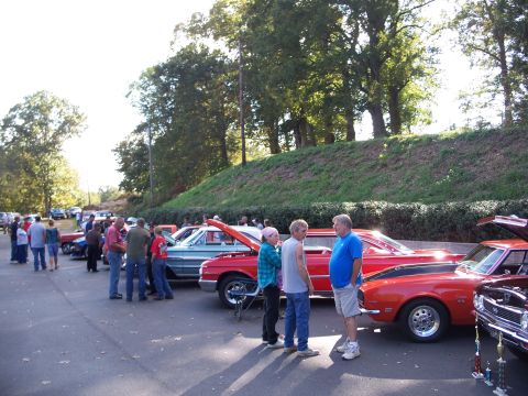 1971 Ford Ranchero - Several classic cars are on display at an outdoor gathering, with a red Camaro prominently featured.
