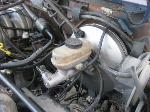 1994 Ford Bronco - Close-up view of the brake master cylinder and booster assembly, part of the braking system.