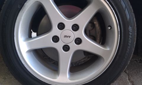 2004 Ford Crown Victoria - Close-up of a wheel an SVT center cap and Hankook tire tread.