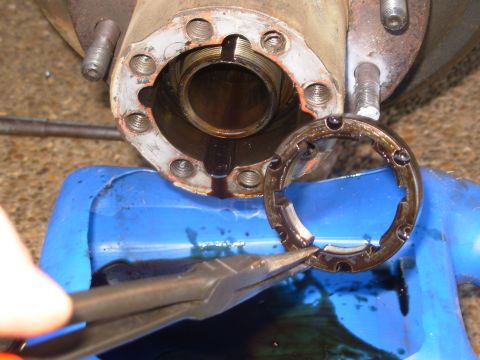 1997 Chevrolet Silverado 3500 - The ground-down tips of the pliers fit in the round holes, making it easy to spin the nut off.