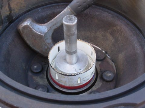 1997 Chevrolet Silverado 3500 - My largest seal/bearing driver isn't quite big enough, so I'm using the heavy backing plate of this 4" hole saw. It's a perfect fit.