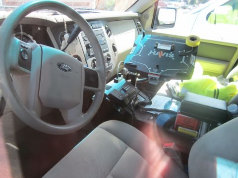 1991 Ford LTD Crown Victoria - The interior of a Ford police vehicle shows a Havis console, radio, and other equipment.