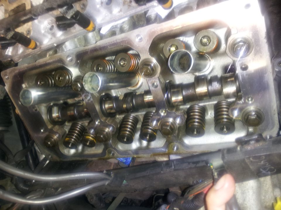 engine cylinder head with camshafts, valves, and springs visible