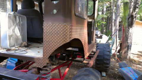 1978 Ford Bronco - A heavily modified vehicle sits outdoors, showing its custom suspension and large off-road tires.