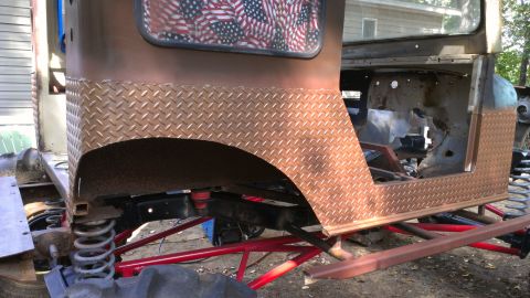 1978 Ford Bronco - This custom off-road vehicle features diamond plate body panels and an American flag window covering, appearing to be under construction.
