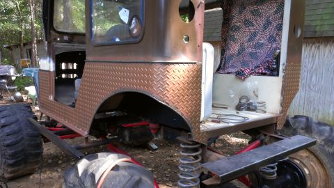 1978 Ford Bronco - This heavily modified vehicle is in a state of disrepair, with exposed suspension and unfinished bodywork.