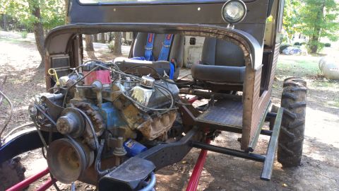 1978 Ford Bronco - This custom build features a prominent engine and large tires, with racing seats visible inside the cabin.