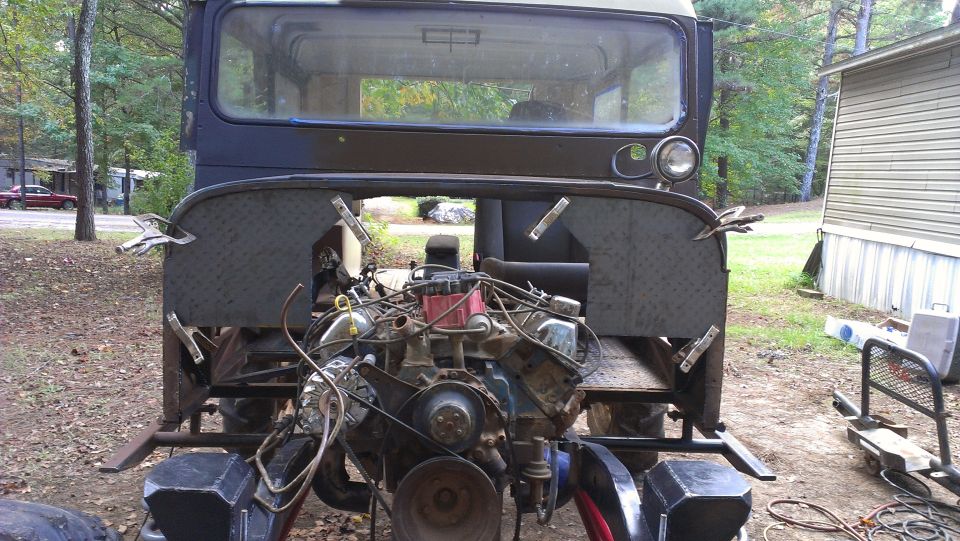 Custom off-road vehicle with engine exposed, viewed from rear