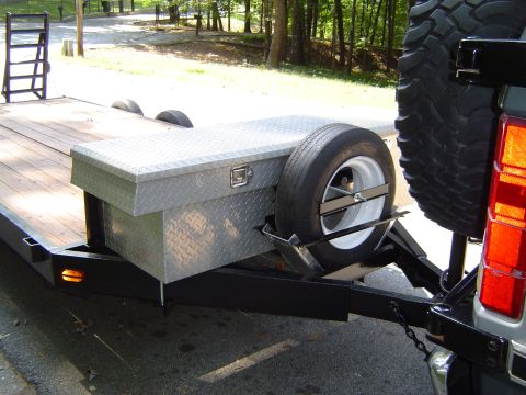 1986 Ford Bronco - A diamond plate toolbox and spare tire are mounted on the tongue of a utility trailer.