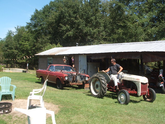 1966 Ford Ranchero with front end removed, being towed by a tractor