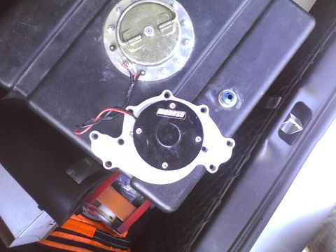 2003 Ford Crown Victoria - Close-up of an AEM fuel pump assembly mounted on a fuel tank.