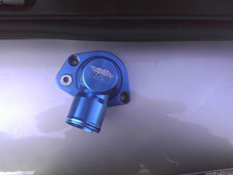 2003 Ford Crown Victoria - Close-up of a blue aluminum thermostat housing with CSR branding.