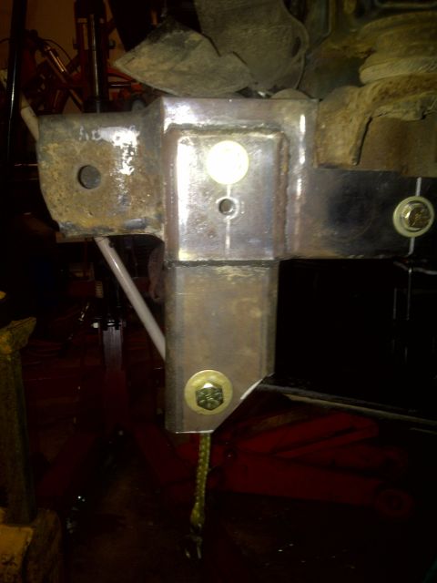 1995 Ford Bronco - Close-up of a custom welded bracket on a vehicle's frame, showing mounting hardware.