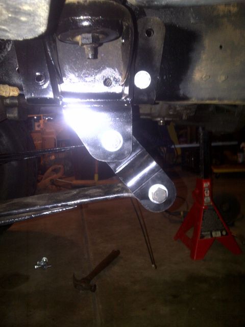 1995 Ford Bronco - A close-up view of a vehicle's suspension system, focusing on a newly installed bracket.