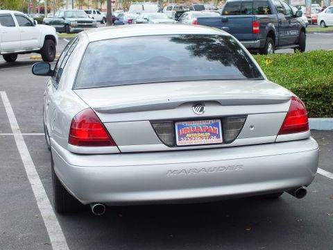 2003 Ford Crown Victoria - Silver Marauder rear with chrome exhaust tips and an Uruapan Auto Sales plate frame in a lot