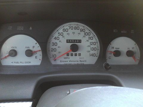 2003 Ford Crown Victoria - The dashboard gauges show 'Crown Victoria Sport' and have readable text and numbers.