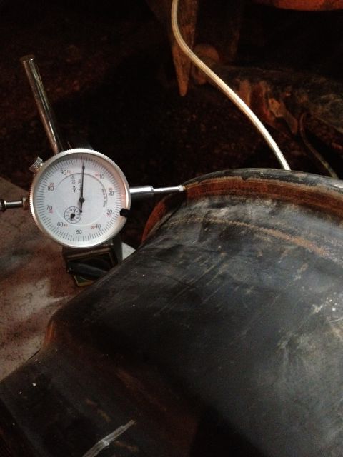 1989 Ford Bronco - A dial indicator is used to measure the rim of a tire, likely for precision work.