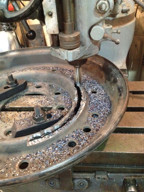1989 Ford Bronco - Brake drum being machined on a milling machine with metal shavings.