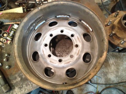 1989 Ford Bronco - A single metal wheel rim is shown, with a second hub assembly visible to the right.