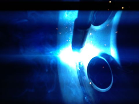 1989 Ford Bronco - Welding sparks fly around an exhaust pipe, obscuring any vehicle details.
