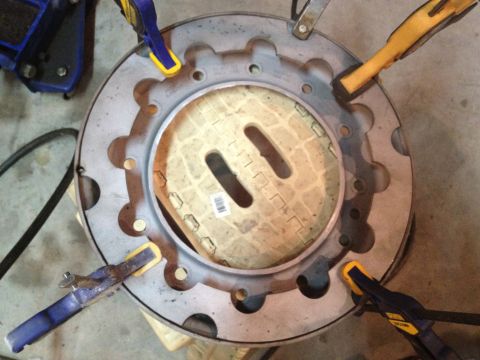 1989 Ford Bronco - A close-up view of a wheel rim secured with clamps, revealing a patterned insert.