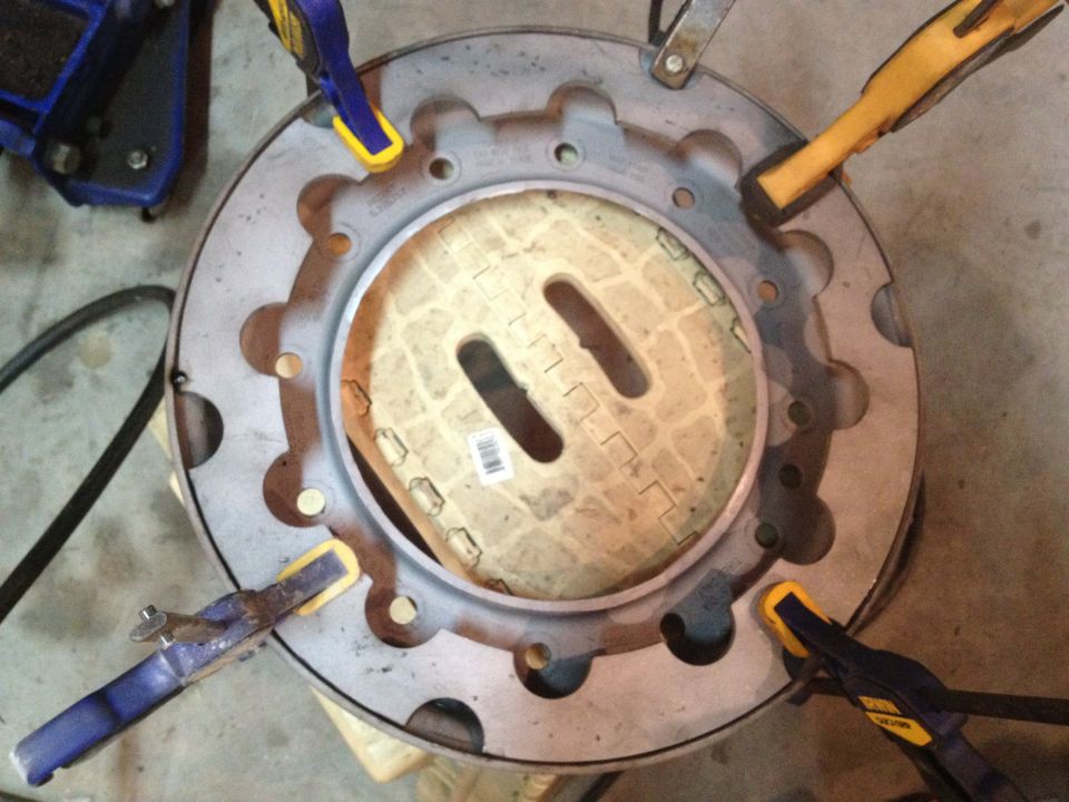 Wheel rim held by clamps, with a patterned cover inside