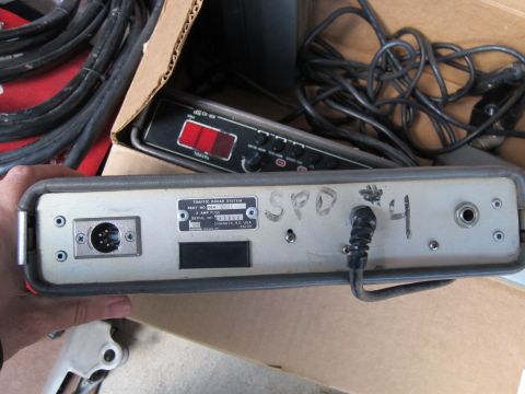 1991 Ford LTD Crown Victoria - Rear panel of a traffic radar system unit with its identification data plate (2 AMP fuse, serial number, made in Chanute, KS USA), connecto…