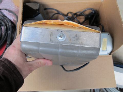 1991 Ford LTD Crown Victoria - A gray electronic component with visible wiring and damaged foam padding is held in a cardboard box.